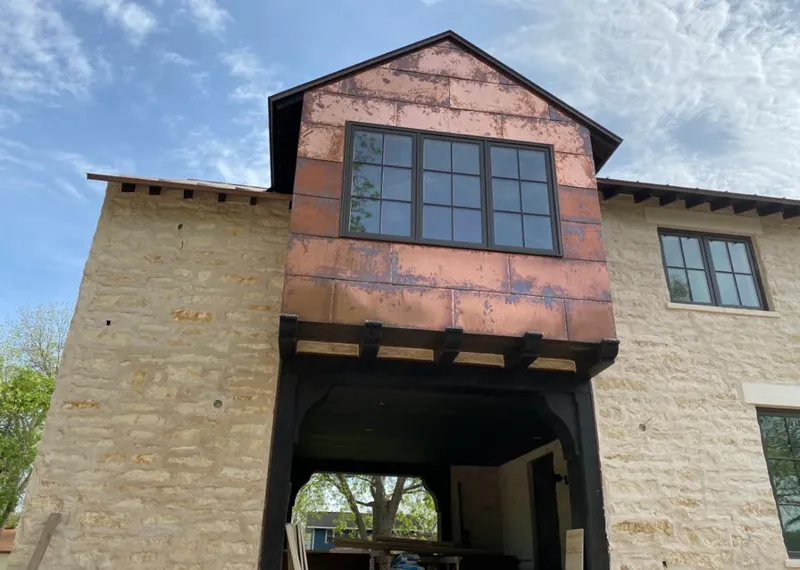 Copper metal panel facade on a stone building for Skylight Installation in Litchfield Beach